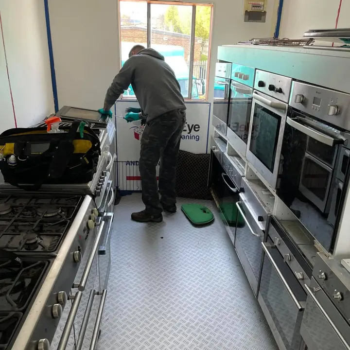 A trainee working on ovens in the training workshop