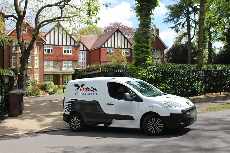 A white Eagle Eye Oven Cleaning van parked on a residential road